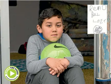  ?? PHOTO: WARWICK SMITH/FAIRFAX NZ ?? Te Kahu Hall. 6, is keeping his new green ball close. He doesn’t want it to get dirty, let alone lost. Inset: Te Kahu’s ‘‘lost’’ poster.