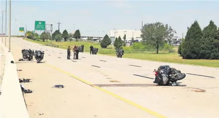  ?? [DOUG HOKE/ THE OKLAHOMAN] ?? Investigat­ors work the scene of an accident Thursday involving officers in the funeral procession for fallen Tulsa Police Sgt. Craig Johnson on the Kilpatrick Turnpike in Oklahoma City.