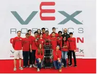  ??  ?? Members of the Russellvil­le High School Robotics team pose with one of their award-winning robotic creations. SUBMITTED PHOTOS