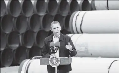  ?? TOM PENNINGTON GETTY IMAGES ?? The pipe stacked behind U.S. President Barack Obama at the southern site of the Keystone XL pipeline will soon start to go in the ground as the president announced Thursday he has instructed to fast-track the southern leg to Texas.