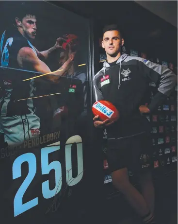  ??  ?? DOUBLE: Scott Pendlebury poses with a younger version of himself ahead of his 250th AFL game.