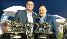  ??  ?? WINNING CAMPAIGN. Jason van der Bank (left) with all the stable trophies after Walter Smoothie won the Listed Racing Associatio­n Handicap over 3200m on Saturday for the Stuart Pettigrew yard. He enjoyed the moment with cousin Tyron Vermaak.