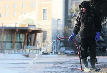  ?? MICHELLE BERG/FILES ?? Council approved $45,000 to help the Meewasin Valley Authority run the popular downtown skating rink. On a bitterly cold morning last December, Herem Devin Ostlund was at work flooding the site.