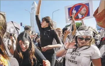  ?? Irfan Khan Los Angeles Times ?? PROTESTERS converge on Grand Park in L.A. on Jan. 20, 2018, when cities across the U.S. played host to the second Women’s March. The first march, in 2017, was organized in response to the then-new administra­tion.