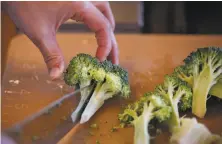  ?? Leah Millis / The Chronicle ?? Karen Yu chops broccoli in a class that is part of City College of San Francisco’s free Culinary Arts Basic Skills Training.