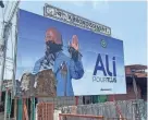  ?? AFP VIA GETTY IMAGES ?? A defaced campaign billboard for ousted Gabon President Ali Bongo Ondimba is seen in the capital, Libreville, on Thursday.
