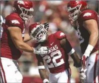  ?? (NWA Democrat-Gazette/Charlie Kaijo) ?? Arkansas running back Trelon Smith (center) celebrates with teammates following a score during Saturday’s 45-10 victory over Georgia Southern. The No. 16 Razorbacks (3-0) will face No. 7 Texas A&M (3-0) this Saturday in Arlington, Texas.