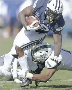  ?? Rick Bowmer/Associated Press ?? Portland State safety Tyler Foreman tackles BYU running back Squally Canada in the second half of the Cougars’ 20-6 win.