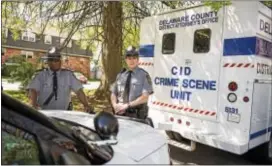  ?? RICK KAUFFMAN — DIGITAL FIRST MEDIA ?? Troopers Jim Lark and Patrick McMillan from the Media Barracks of the Pennsylvan­ia State Police stand on the corner of 22nd Street and Edgmont Avenue in Chester, where the first homicide of the year took place.