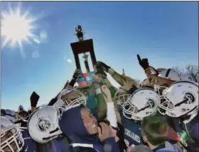  ?? DIGITAL FIRST MEDIA FILE PHOTO ?? In this file photo from 2012, Pottstown celebrates their Thanksgivi­ng Day victory over OJR by hoisting the series trophy overhead. The Wildcats and Trojans will discontinu­e their Thanksgivi­ng Day rivalry in 2018, citing a multitude of reasons behind the decision.