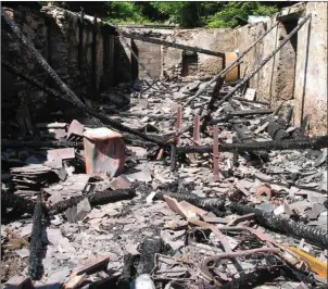  ??  ?? The inside one of the sheds following the fire in the sawmill yard at God’s Cottage.