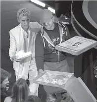  ?? Photo by John Shearer/Invision/AP, File ?? ■ In this March 2, 2014, file photo, host Ellen DeGeneres passes out pizza to the audience during the Oscars in Los Angeles.