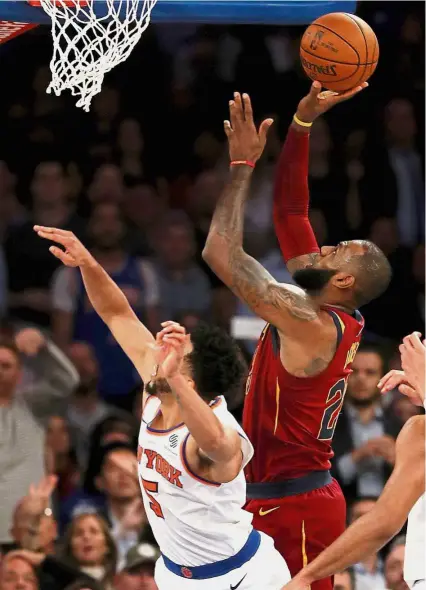  ??  ?? Here goes: Cleveland Cavaliers’ LeBron James taking a shot over New York Knicks’ Courtney Lee at Madison Square Garden on Monday. – AFP