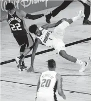  ?? [CHARLES KING/ORLANDO SENTINEL] ?? Magic forward Jonathan Isaac (1) falls to the floor after injuring his left knee against the Kings on Sunday.