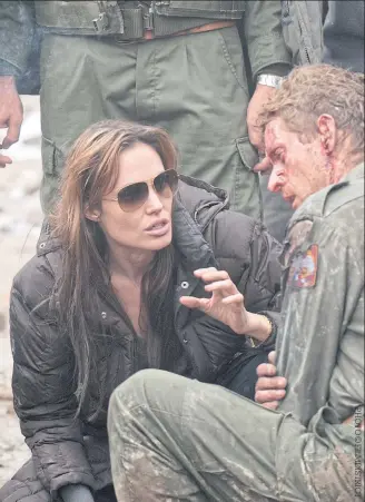  ??  ?? Angelina Jolie on the set of In The Land Of Blood And Honey, her directoria­l debut, in 2011.