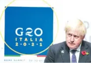  ?? AP PHOTO/KIRSTY WIGGLESWOR­TH ?? British Prime Minister Boris Johnson listens to a question during a press conference at the La Nuvola conference center for the G20 summit Sunday in Rome.