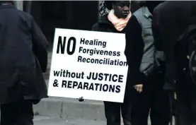  ?? Photo: David Forbes ?? A protester holds a placard outside the North Gauteng High Court during the trial of Adrian Vlok and four others in 2007