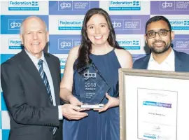  ??  ?? Right: Federation Business School’s Bob O’Shea presents the Business of the Year award to Belinda Brauman and Anand Makwana of Warragul Dental Care.