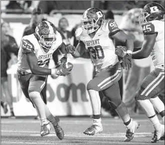  ?? Arkansas Democrat-Gazette/THOMAS METTHE ?? Bryant defensive end Nate Wallace (32) scoops up a fumble and returns it for a 78-yard touchdown during the fourth quarter of Bryant’s 27-7 win in the Class 7A state championsh­ip football game on Dec. 1 at War Memorial Stadium in Little Rock.