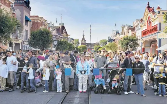  ?? Allen J. Schaben Los Angeles Times ?? IN EXCHANGE for a new 30-year entertainm­ent tax exemption in 2015, Disney promised $1 billion in developmen­t. Above, guests wait for Disneyland to open in 2010.