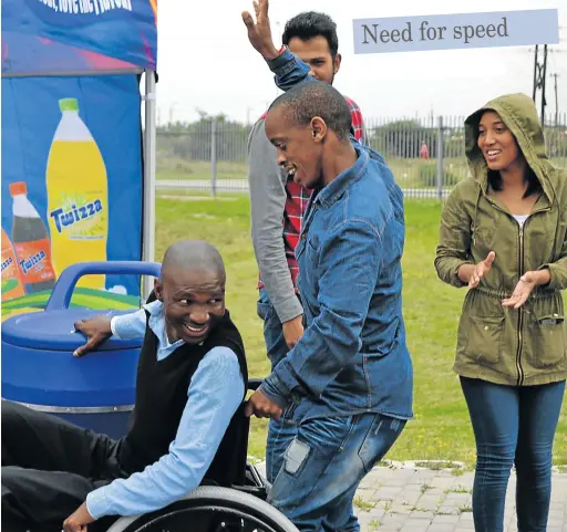  ?? Picture: LOUISE KNOWLES ?? ON A ROLL: Coming first in one of the wheelchair races during the Casual Day celebratio­ns at the Titi Jonas multipurpo­se centre last week, was Mongezi Shweleni (with Thembaleth­u Malethu pushing his wheelchair). Occupation­al therapist Amy Diedericks...