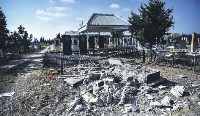  ??  ?? A cemetery damaged by Armenian shelling in the Tartar province of Azerbaijan, Oct. 15, 2020.