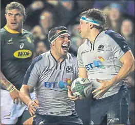  ??  ?? Stuart Mcinally celebrates after Hamish Watson had scored Scotland’s second try at Murrayfiel­d