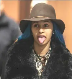  ?? — Reuters photos ?? Cardi B sticks out her tongue during her arraignmen­t at Queens County Criminal Court in the Queens Borough of New York, on Friday. (Left) Cardi B leaves Queens County Criminal Court.