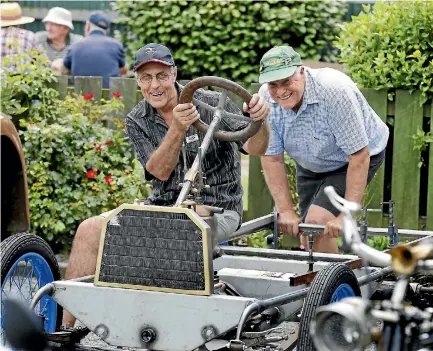  ?? PHOTO: JOHN BISSET/STUFF ?? Lex Westoby and Ashley Milliken at the South Canterbury Vintage Car Club open day. Westoby sits in the 1905 Helbe he is building.