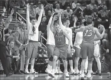  ?? Associated Press ?? Moving on: Marshall guard Jon Elmore (33) reacts after making a three-point shot during the second half of a first-round NCAA Tournament game against Wichita State Friday in San Diego.