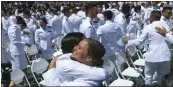  ?? ?? Cadets, now ensigns, congratula­te one another at the end of the U.S. Coast Guard Academy's commenceme­nt ceremony Wednesday.