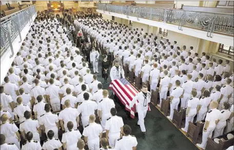  ?? Photograph­s by David Hume Kennerly McCain family ?? THE CASKET holding Sen. John McCain is carried out of the U.S. Naval Academy chapel after a private service Sunday in Annapolis, Md.