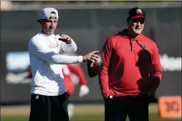  ?? JEFF CHIU — THE ASSOCIATED PRESS ?? San Francisco 49ers head coach Kyle Shanahan, left, and general manager John Lynch watch as players take part in drills during a practice in Santa Clara on Jan. 26.