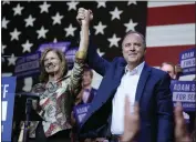  ?? JAE C. HONG — THE ASSOCIATED PRESS ?? U.S. Rep. Adam Schiff, D-Calif., a U.S. Senate candidate, holds hands with his wife Eve at an election night party on Tuesday.