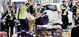  ??  ?? Rescue workers help the injured in Melbourne yesterday