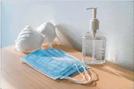  ?? DREAMSTIME/TNS ?? Masks and sanitizing hand gel should be in your travel kit.