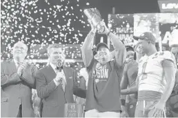  ?? EZRA SHAW/GETTY-AFP ?? Clemson coach Dabo Swinney celebrates with the College Football Playoff national title trophy after his team thrashed Alabama late Monday night in San Jose, Calif.