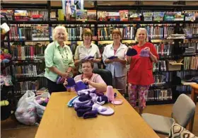  ??  ?? Crochet group pictured with newborn hats made for the Oklahoma State Department of Health for the prevention of shaken baby syndrome.