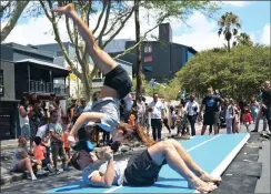  ??  ?? HEAD OVER HEELS: Kahla Hackner somersault­s over Ahren Posthumus. They are both from the UCT gymnastics team.