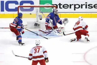  ??  ?? TORONTO: Sebastian Aho #20 of the Carolina Hurricanes scores a goal on Igor Shesterkin #31 of the New York Rangers during the third period in Game Three of the Eastern Conference Qualificat­ion Round prior to the 2020 NHL Stanley Cup Playoffs at Scotiabank Arena in Toronto, Ontario, Canada. — AFP