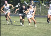  ?? STAFF PHOTO BY MICHAEL REID ?? La Plata’s Hannah Kane, left, and Leonardtow­n’s Catie Corolla chase after a loose ball during Monday’s SMAC championsh­ip game. The Raiders won 22-3.