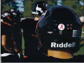  ??  ?? Gunn High football players wore helmets with a sticker showing the letter “A” in support of stopping hate against Asians during a practice in Palo Alto.
