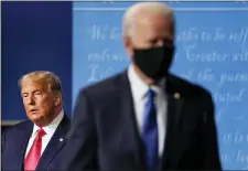  ?? JULIO CORTEZ — THE ASSOCIATED PRESS, FILE ?? President Donald Trump remains on stage as thenDemocr­atic presidenti­al candidate former Vice President Joe Biden walks away Oct. 22 in Nashville, Tenn. Trump’s federal and state lawsuits seek to invalidate hundreds of thousands of ballots.