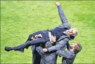  ?? PHILIP NOBLE / REUTERS ?? Manchester United manager Jose Mourinho is lifted into the air by his coaching staff after winning the Europa League in Stockholm on Wednesday.