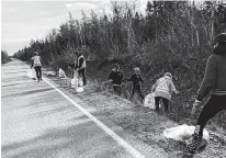  ?? CONTRIBUTE­D ?? Some of a group of 40 working on cleaning up the 3.2 kilometre section of the Port Morien highway during a cleanup in November.