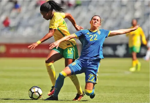  ??  ?? TOUGH BATTLE: Jermaine Seoposenwe is tackled by Olivia Schough at Cape Town Stadium yesterday.