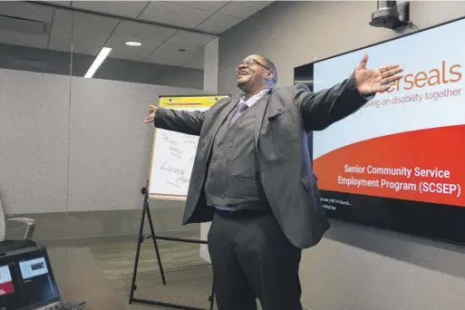  ?? PAT NABONG/SUN-TIMES PHOTOS ?? Nazareth Wilson, program specialist at Garfield Park Behavioral Hospital, sings to the audience before giving a talk about how he got involved with Easterseal­s’ Senior Community Service Employment Program. The program helps low-income older adults with job placement and training.