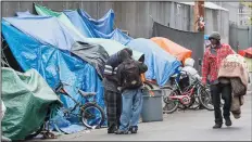  ?? BRIAN VAN DER BRUG/LOS ANGELES TIMES FILE PHOTOGRAPH ?? Homeless people set up tarps and tents in downtown Los Angeles in May 2016. More elderly people are joining the ranks of the homeless.