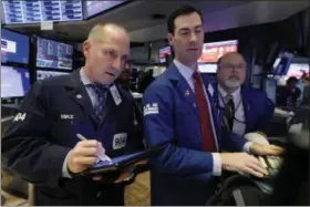  ?? RICHARD DREW ?? FILE- In this Friday, Nov. 9, 2018, file photo trader Michael Urkonis. left, works with specialist­s John McNierney, center, and Douglas Johnson on the floor of the New York Stock Exchange. The U.S. stock market opens at 9:30a.m. EDT on Wednesday, Nov. 21. (AP Photo/Richard Drew, File)