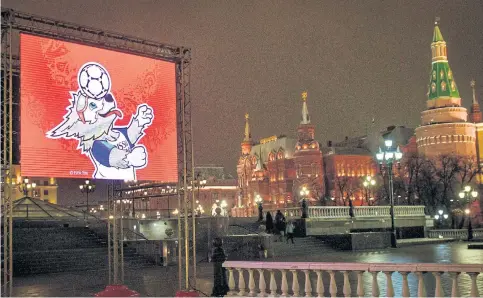  ??  ?? A video screen shows 2018 World Cup mascot Zabivaka on the Manezhnaya Square outside the Kremlin in Moscow.